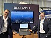 To menn står ved Brunvolls utstillingsstand med skjermer som viser maritim teknologi.